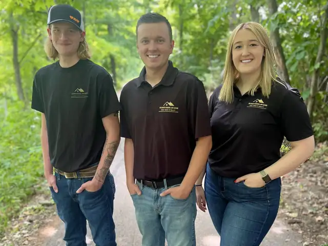 Broc McCabe, Joe Goldsmith and Lexie Goldsmith in Goldsmith Remodel and Design shirts outdoors
